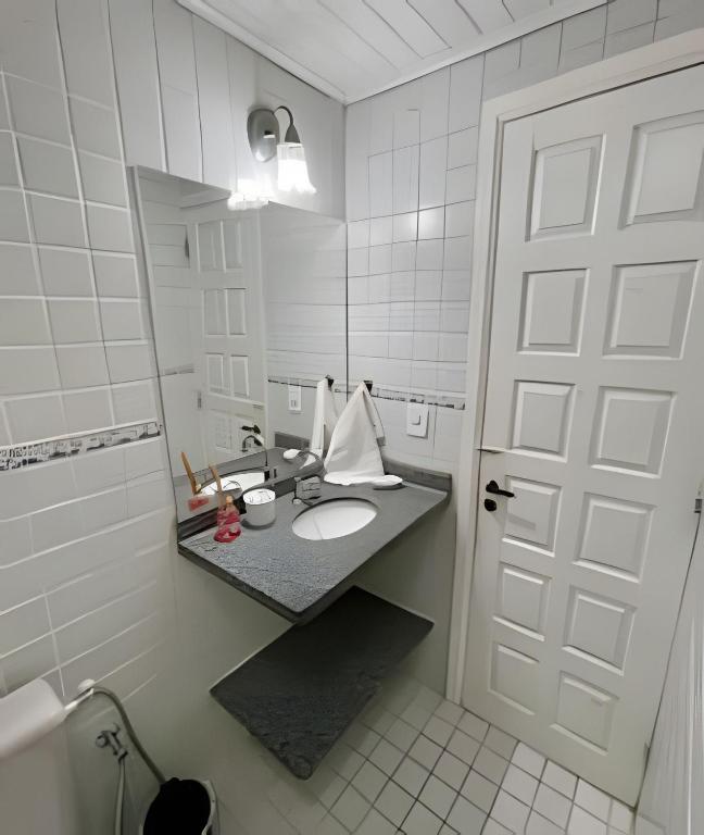 a bathroom with a sink and a mirror at Casa da Lua Centro in Búzios