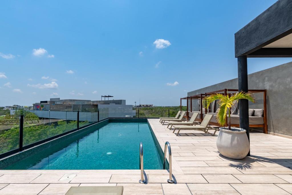 a swimming pool on the roof of a building at Top Location Studio with Rooftop Pool, Gym and Padel Court in Tulum