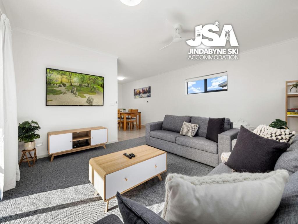 a living room with a couch and a table at Berridale Bliss in Berridale