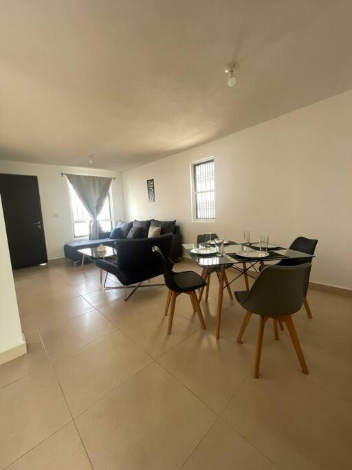 a living room with a couch and a table and chairs at Alojamiento en León in Santa Gertrudis