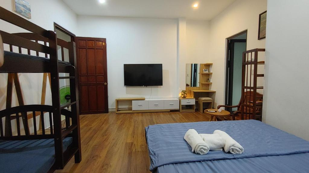 a bedroom with a bunk bed and a flat screen tv at Phe's House in Da Nang