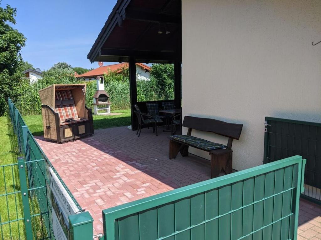 a patio with a bench and a table and a grill at Eul K3 completely fenced in Großwürden