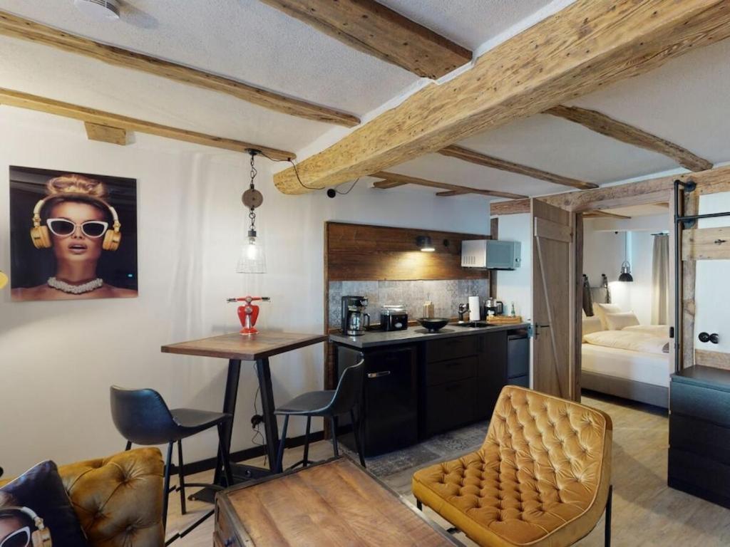 a kitchen and living room with a table and chairs at holiday apartment Vollmer´s Hof in Bad Berleburg