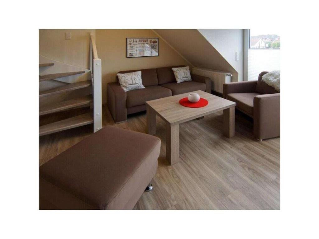 a living room with a couch and a table at Holiday apartment Balkenstek in Norddeich