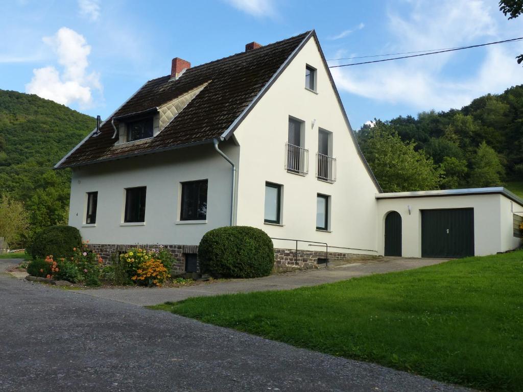 a white house with a black roof at Ferienhaus Fischbachtal in Heimbach