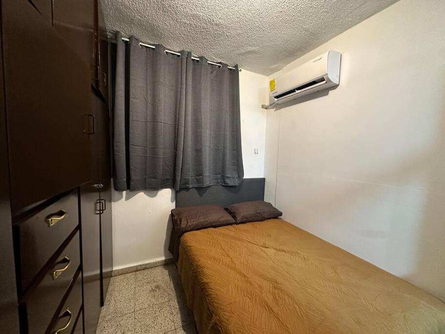 a small bedroom with a bed and a window at Apartamentito Supercéntrico in Monterrey