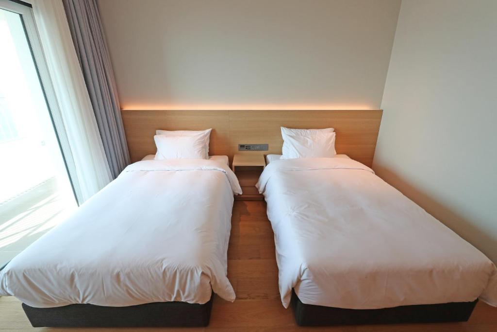 Postel nebo postele na pokoji v ubytování Haenam 126 Hotel