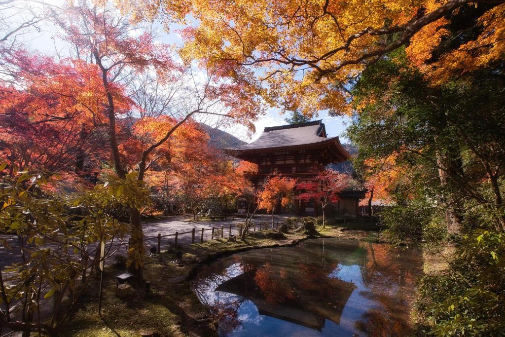 a pagoda in a garden with a pond and trees at JW Marriott Hotel Nara in Nara