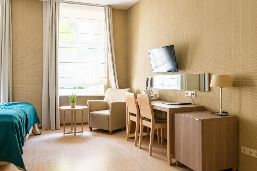 TV a/nebo společenská místnost v ubytování City Hotels Algirdas