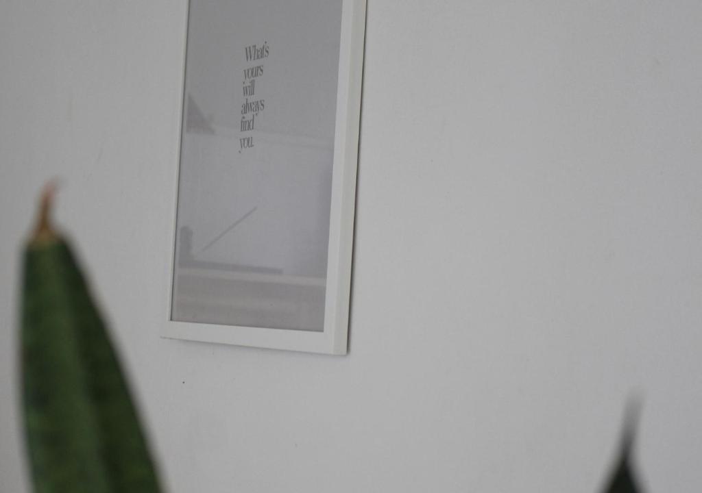 a picture hanging on a wall with a green towel at Calma - Surf, Yoga & Coffee on a Private Beach in Dickwella