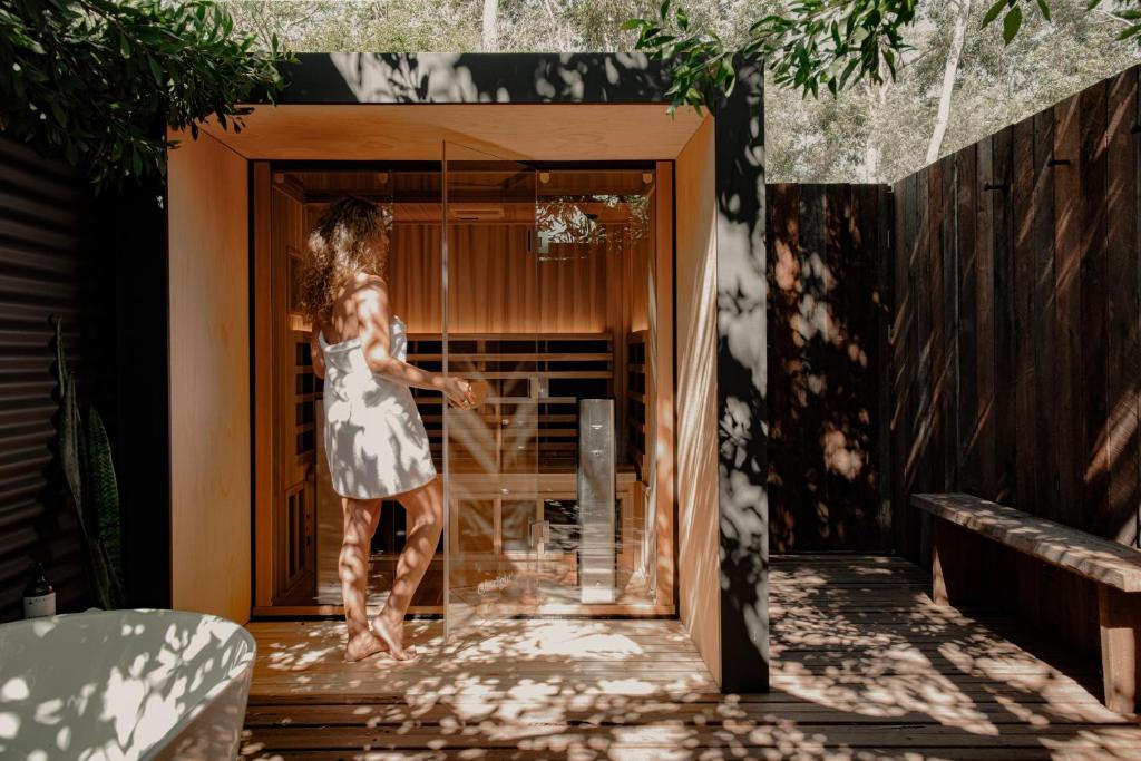 a woman in a dress walking into a doorway at Wellness Escape- Near Town & Beach- Sea La Vie in Margaret River Town