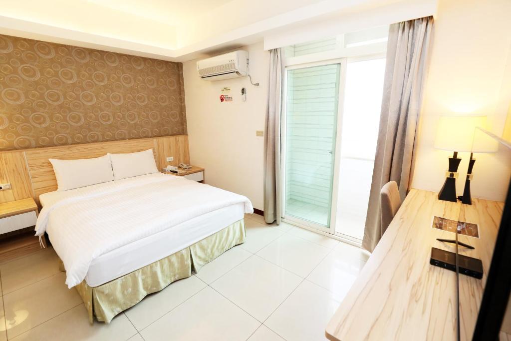 Postel nebo postele na pokoji v ubytování Hoya Resort Hotel Chiayi