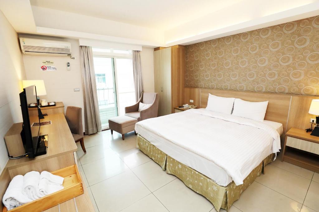 Postel nebo postele na pokoji v ubytování Hoya Resort Hotel Chiayi