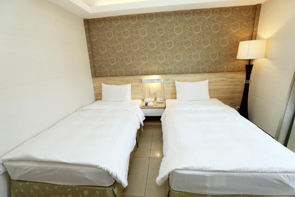 Postel nebo postele na pokoji v ubytování Hoya Resort Hotel Chiayi