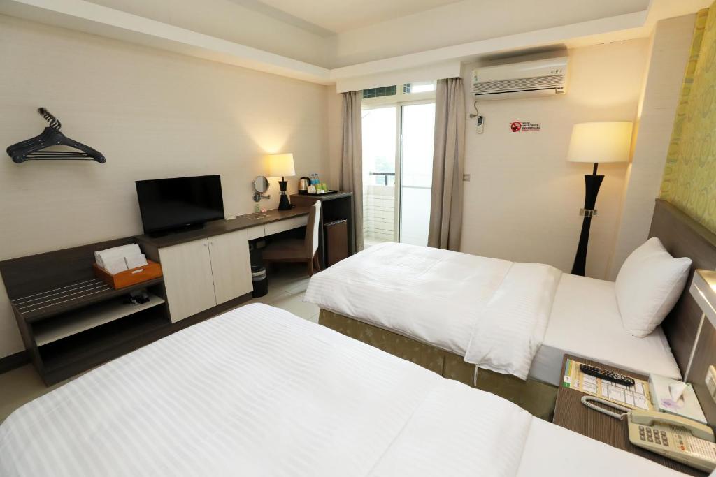 Postel nebo postele na pokoji v ubytování Hoya Resort Hotel Chiayi