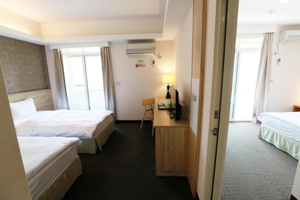 Postel nebo postele na pokoji v ubytování Hoya Resort Hotel Chiayi