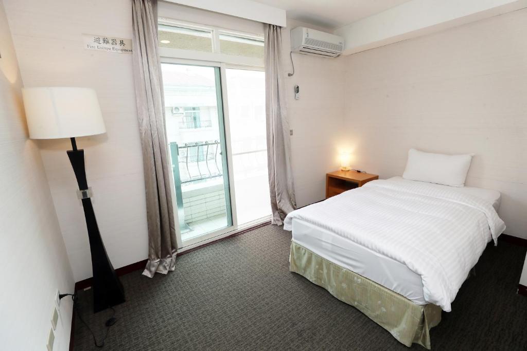 Postel nebo postele na pokoji v ubytování Hoya Resort Hotel Chiayi