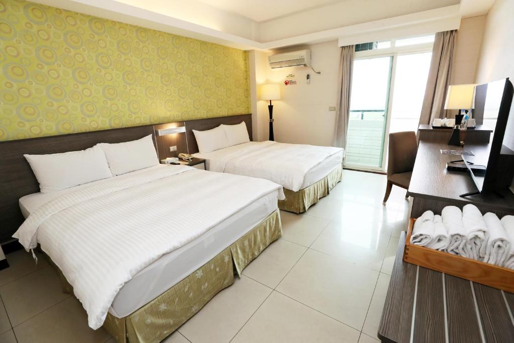 Postel nebo postele na pokoji v ubytování Hoya Resort Hotel Chiayi