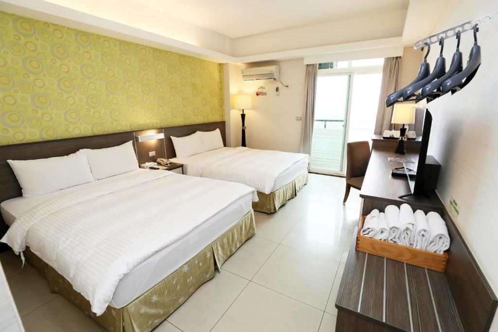 Postel nebo postele na pokoji v ubytování Hoya Resort Hotel Chiayi