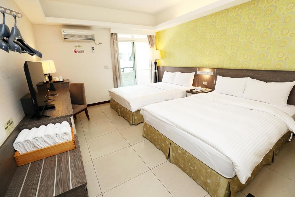 Postel nebo postele na pokoji v ubytování Hoya Resort Hotel Chiayi