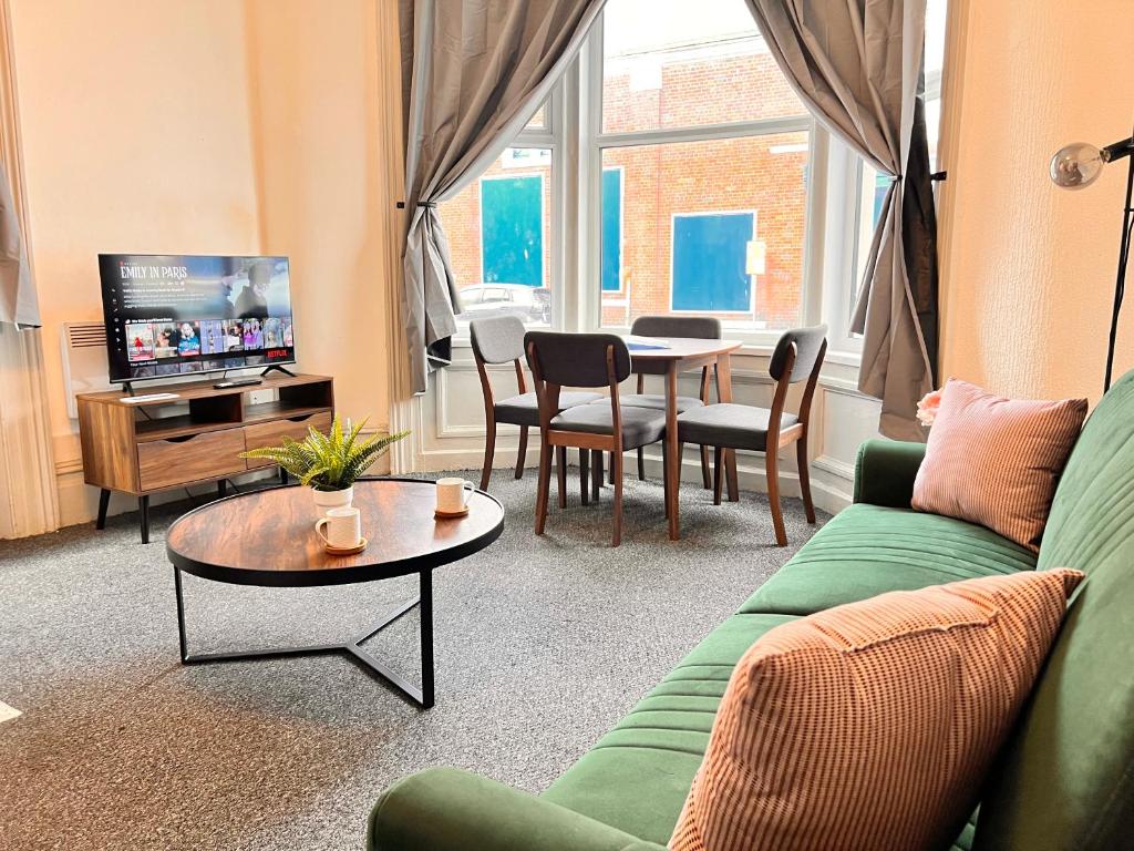 a living room with a couch and a table at Apartment 1 in Blackpool