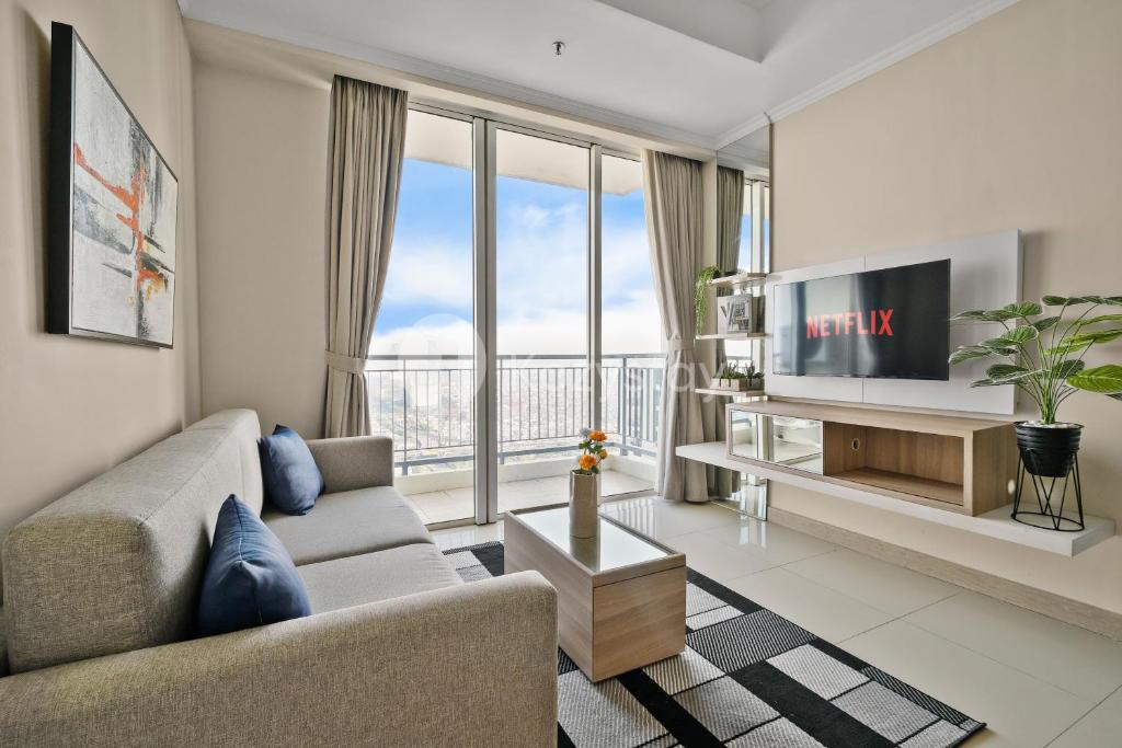 a living room with a couch and a tv at Arcus by Kozystay - Ancol in Jakarta