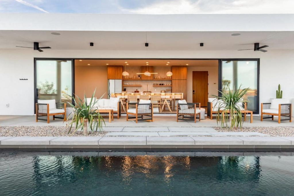 a dining room and kitchen of a house with a pool at Jupiter House by Fieldtrip Modern w Infinity Pool Pickleball in Joshua Tree