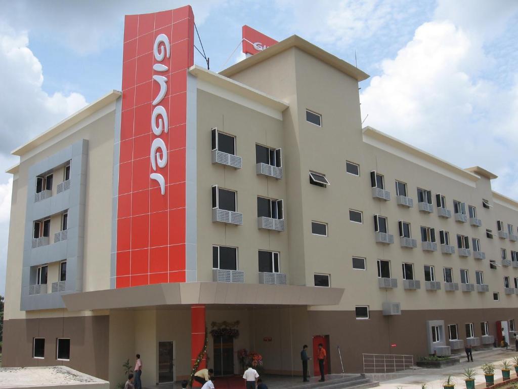 a large building with a red sign on it at Ginger Agartala in Agartala