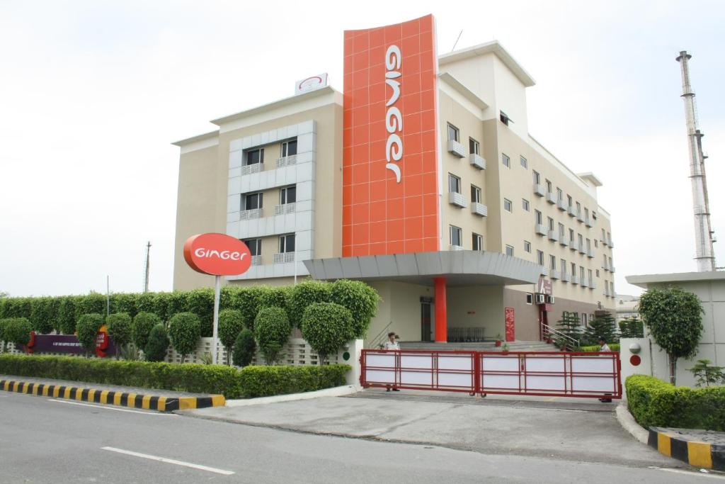 a building with a stop sign in front of it at Ginger Pantnagar in Pantnagar