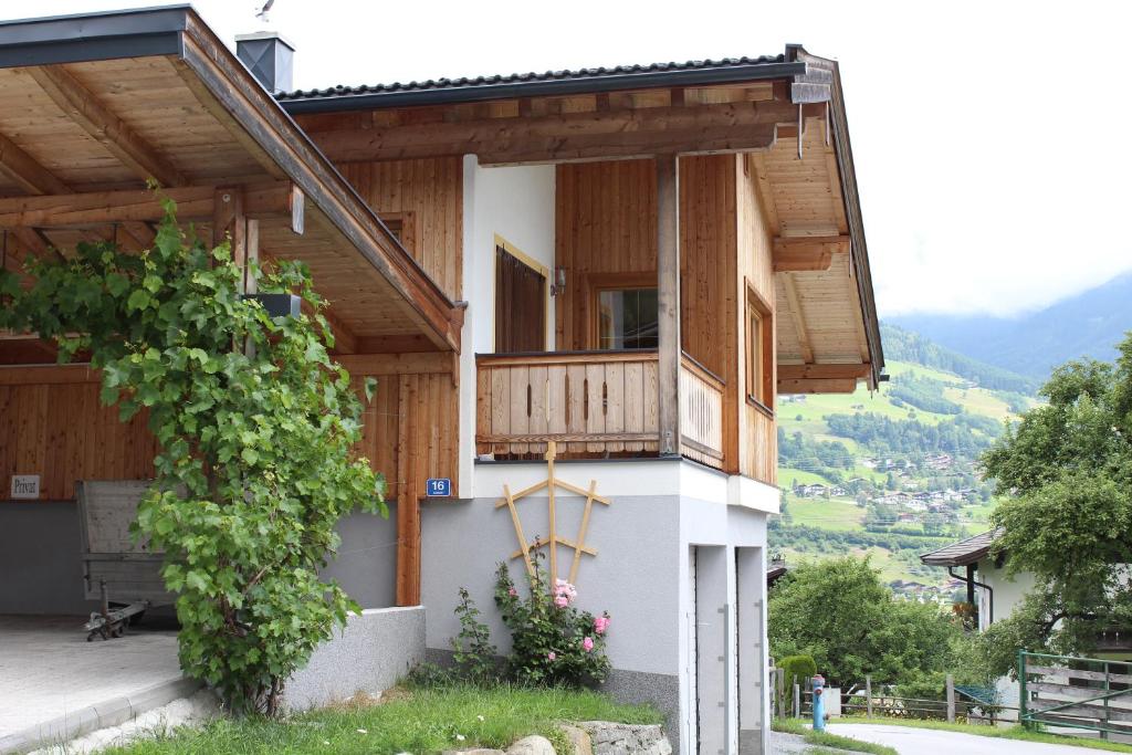 a house with a porch and a balcony at Stöcklgut Ferienhaus in Niedernsill