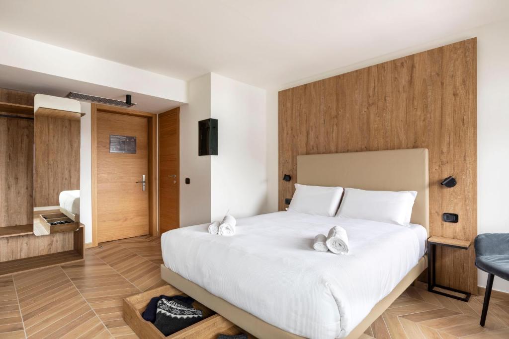 Кровать или кровати в номере B&B Hotel Passo Tre Croci Cortina