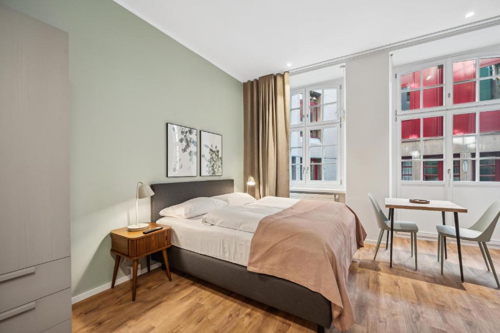 Postel nebo postele na pokoji v ubytování limehome Basel Münzgasse
