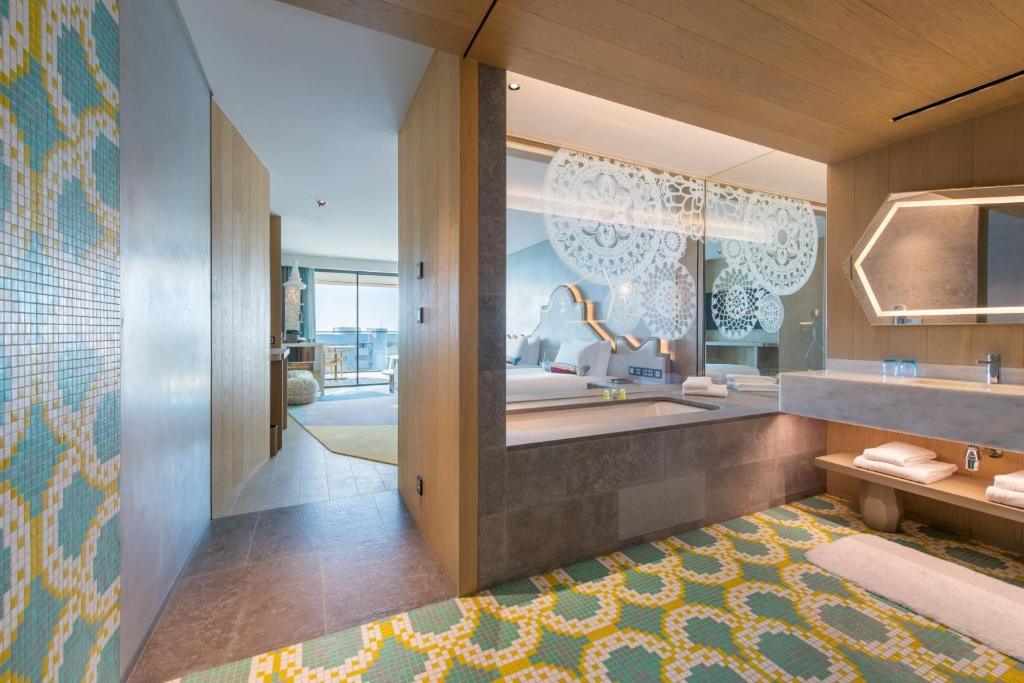a bathroom with a sink and a mirror at W Algarve in Albufeira