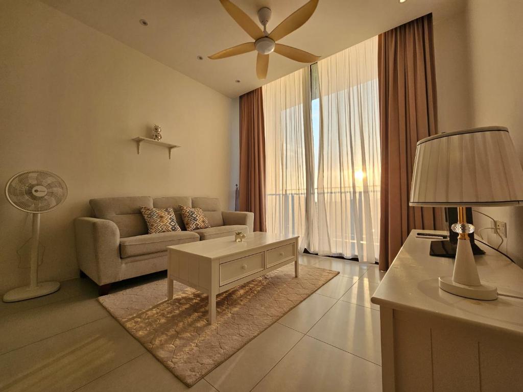 Una sala de estar con un sofá y un ventilador de techo. en The Podium Cozy Style Kuching, en Maong Bazaar