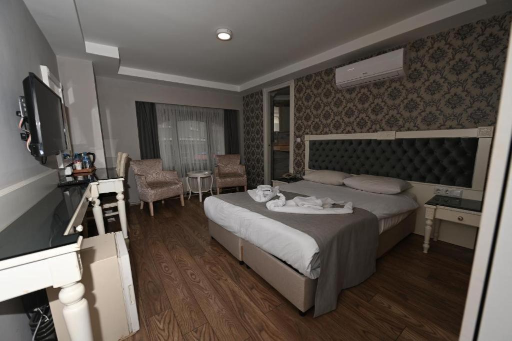 a hotel room with a bed and a television at NkALBATROS HOTEL in Istanbul