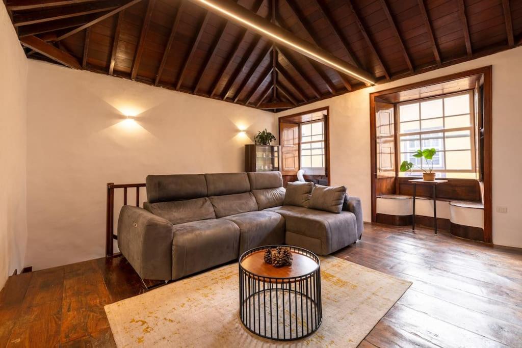 a living room with a couch and a table at EDEN RENTALS La Laguna Heritage Residence in La Laguna