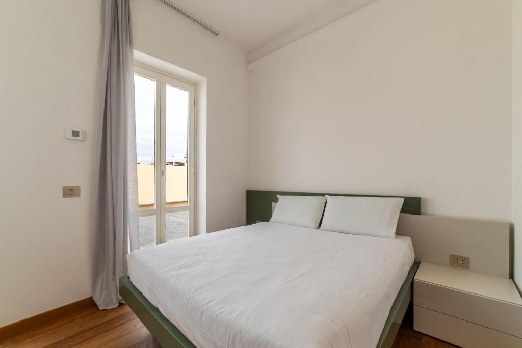 Voodi või voodid majutusasutuse JOIVY Cavour Luxury Apartments toas