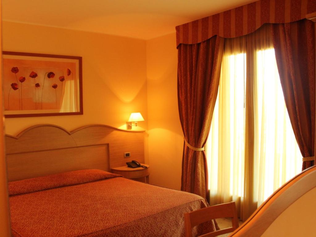 Postel nebo postele na pokoji v ubytování Blu Tropical Resort