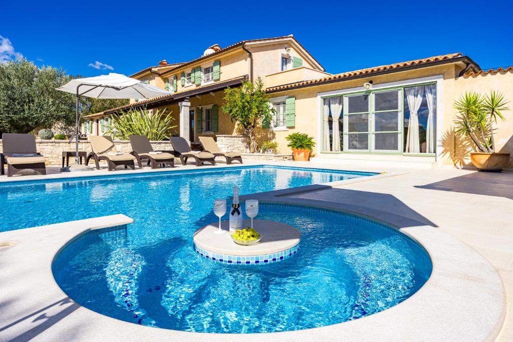 een zwembad voor een huis bij Villa Vlacich for 8 people near Labin - Rabac with heated pool & sea view - only 2 km from beach in Trget