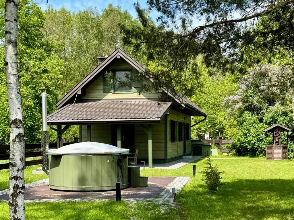 a small green house with a gazebo in the yard at Zielony Jawornik in Jawornik Stary