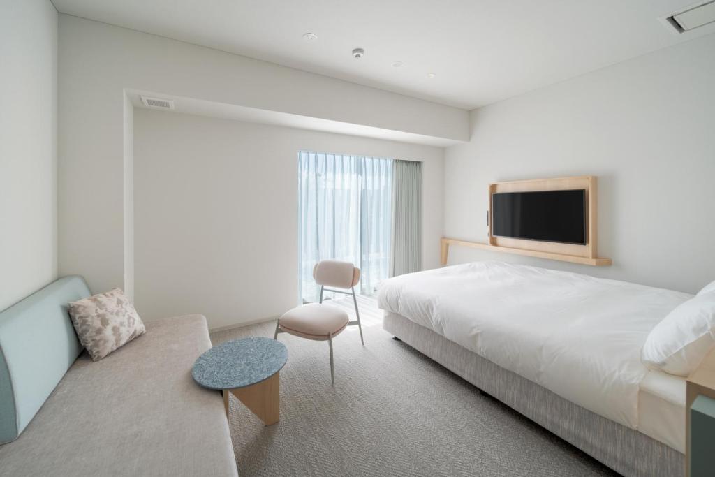 Postel nebo postele na pokoji v ubytování ITOMACHI Hotel 0