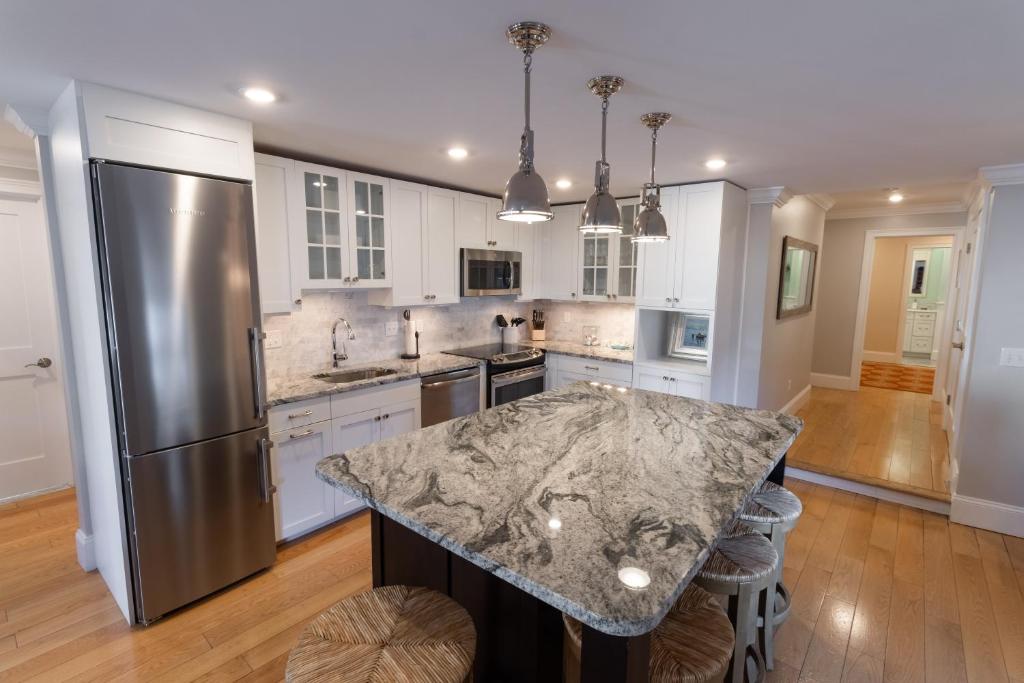a kitchen with a marble counter top and a refrigerator at The Newport Lofts - 548 Thames Street in Newport