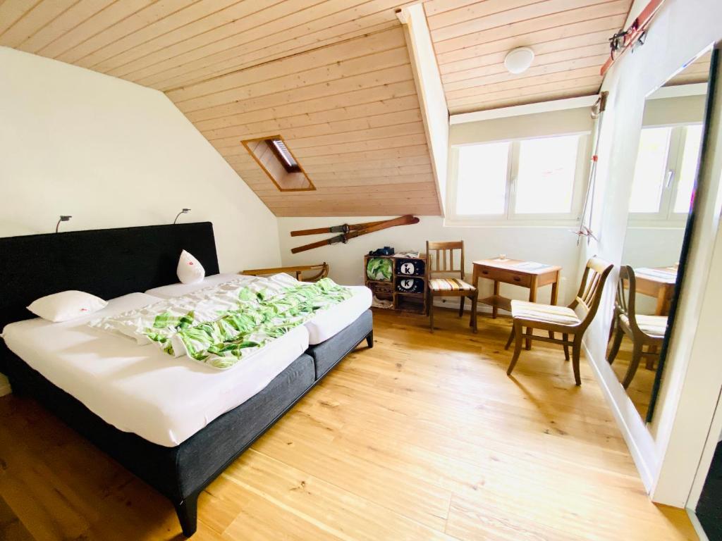 a bedroom with a bed and a table and chairs at Gasthof Kreuz Egerkingen in Egerkingen