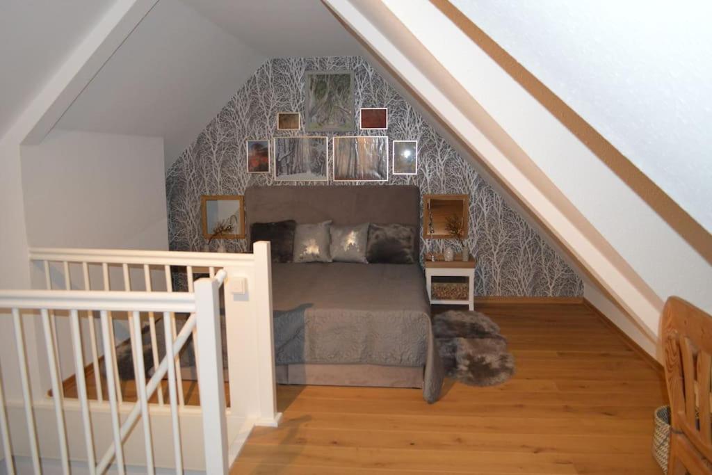 a bedroom with a bed in a attic at Modernes Appartement mit Meerblick in Ahrenshoop