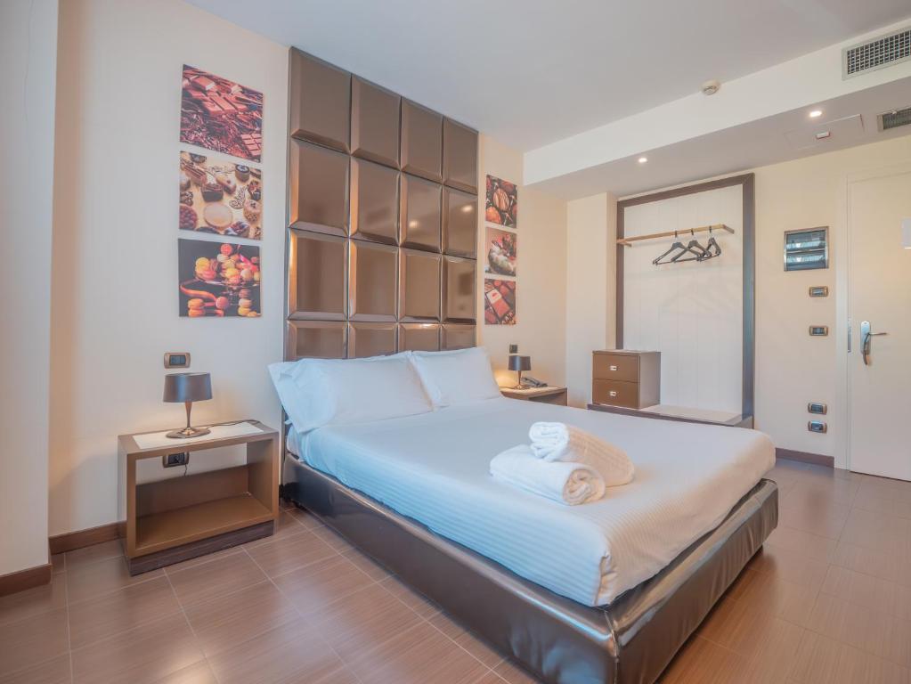 A bed or beds in a room at San Valentino Hotel