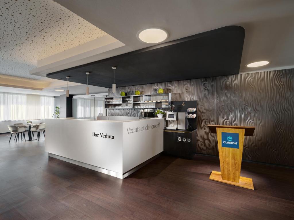 a large room with a counter and a kitchen at Clarion Congress Hotel České Budějovice in České Budějovice