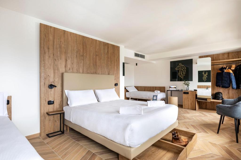 Кровать или кровати в номере B&B Hotel Passo Tre Croci Cortina