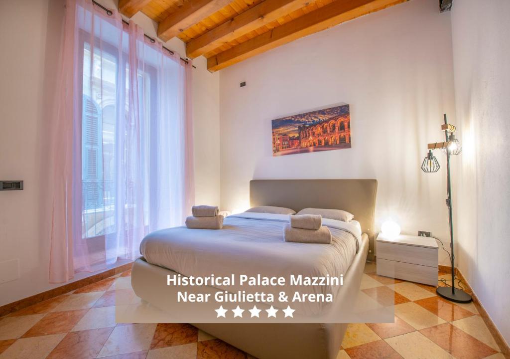 a bedroom with a bed and a large window at HISTORIC CENTER VIEW-2 minutes from Arena & Juliet's house- Mazzini Palace in Verona