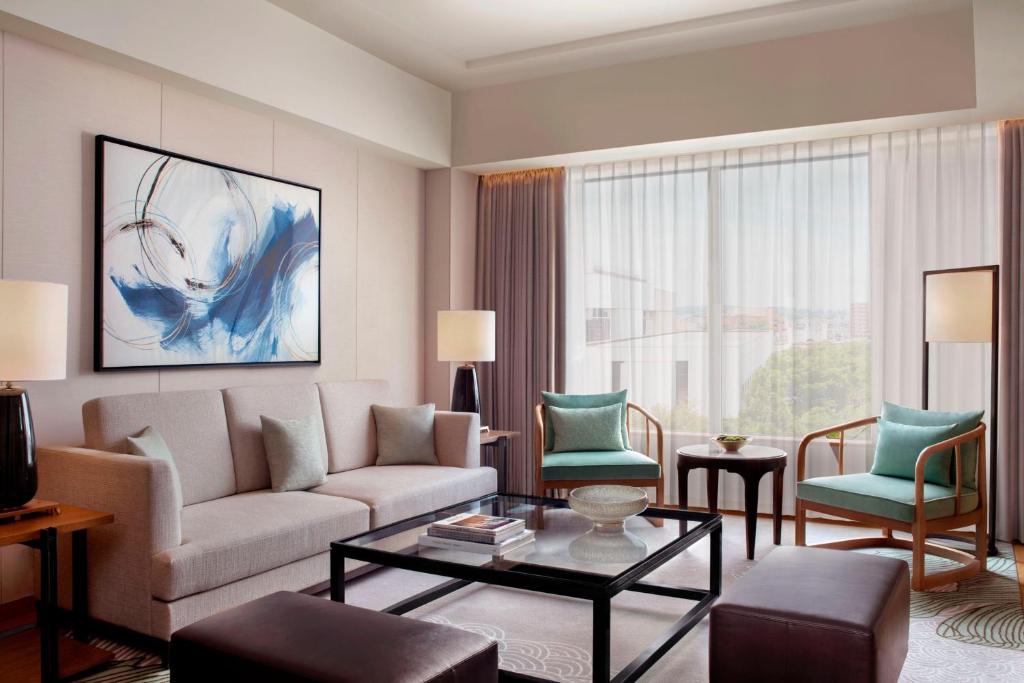 a living room with a couch and two chairs at JW Marriott Hotel Nara in Nara