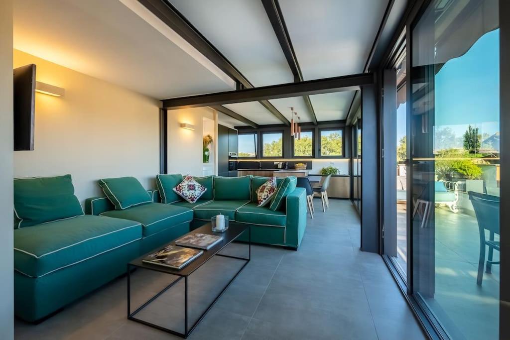 Hotel Della Vittoria Penthouse, a living room with a blue couch and a table at Della Vittoria Penthouse in Rome